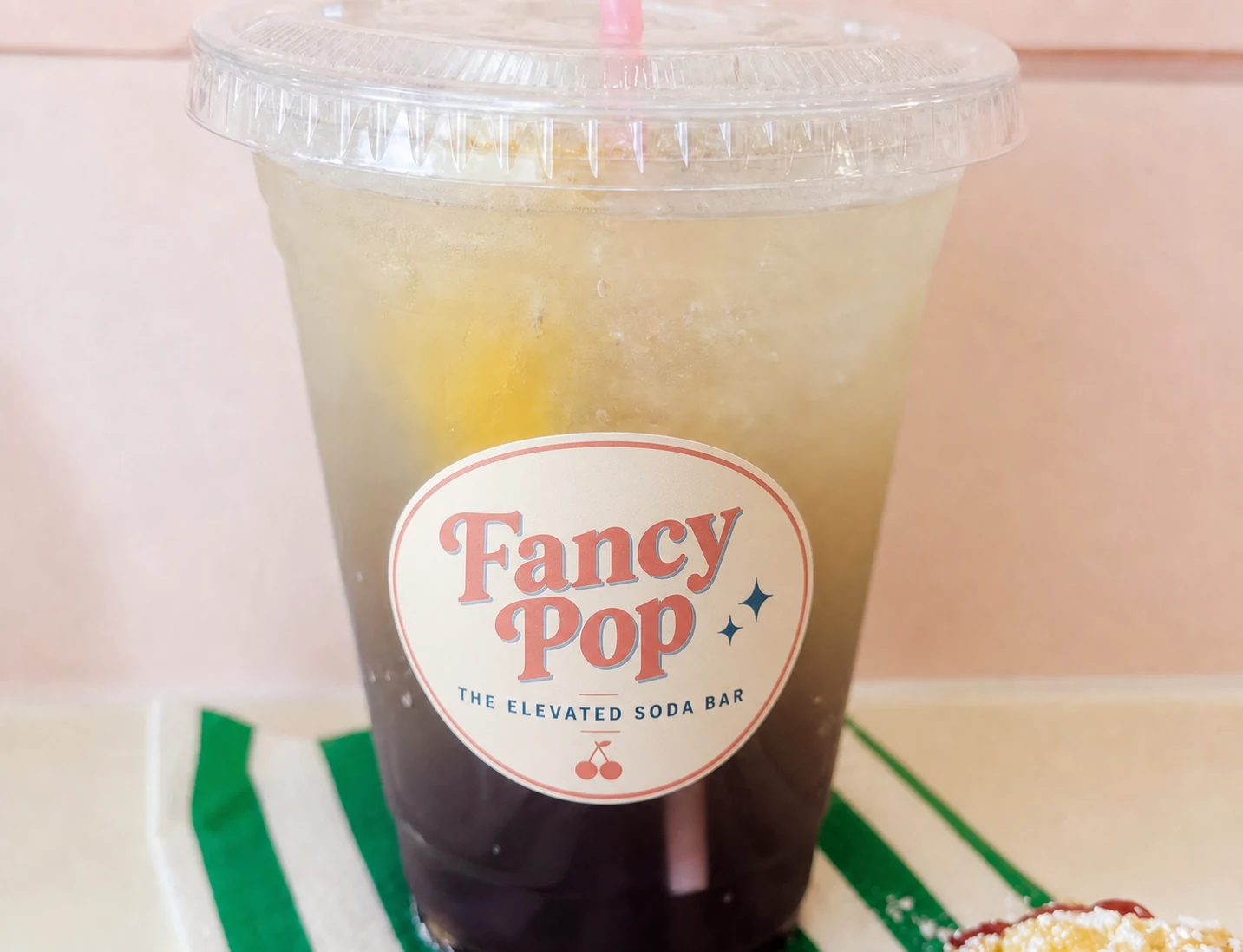 Layered Fancy Pop specialty drink with elevated soda bar label